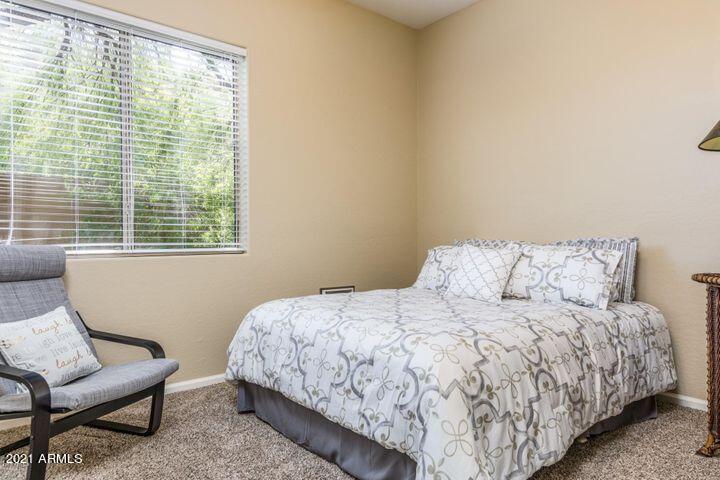 16715 North 108th Way Scottsdale, AZ 85255 - Photo 51 of 104 a bedroom with a bed and a chair