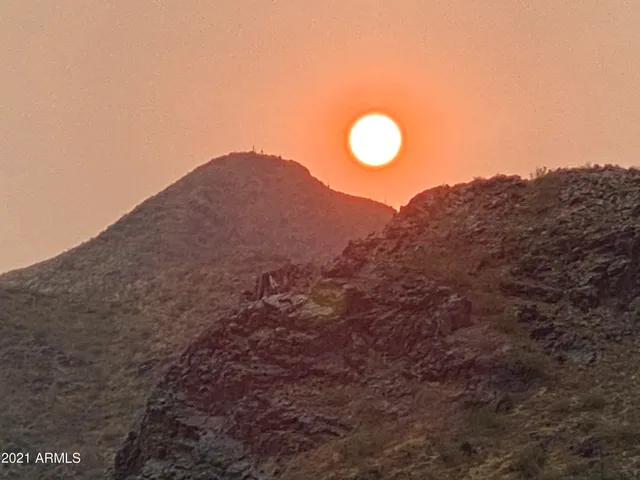 a backyard of a house with barbeque oven table and chairs