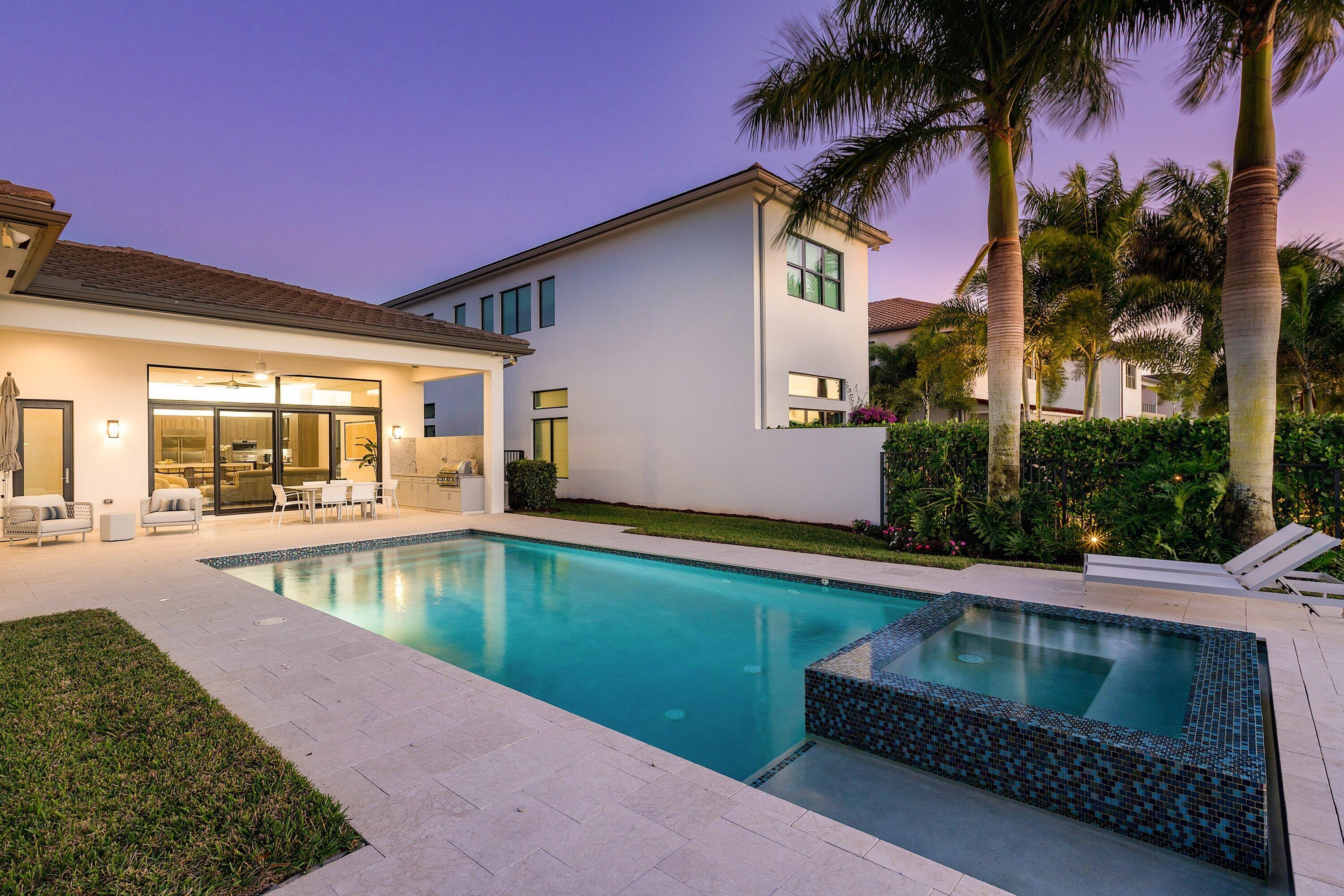 17135 Abruzzo Avenue Boca Raton, FL 33496 - Photo 77 of 95 a view of swimming pool with outdoor seating and house in the background