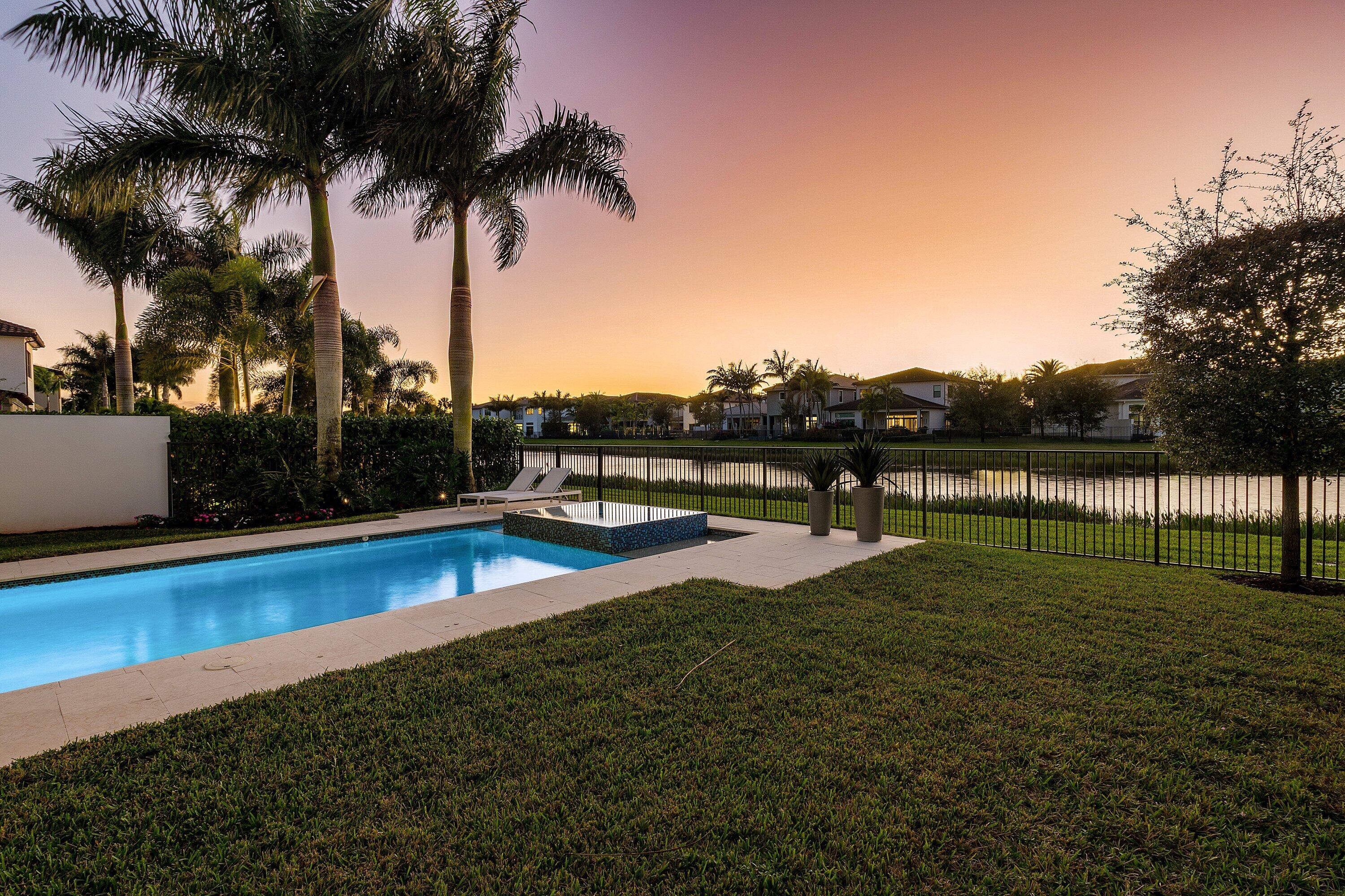 17135 Abruzzo Avenue Boca Raton, FL 33496 - Photo 78 of 95 a view of swimming pool with a yard and palm trees
