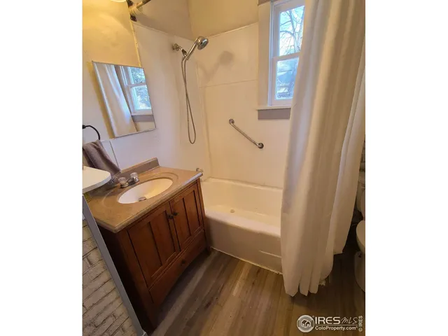 a bathroom with a sink a mirror and a shower