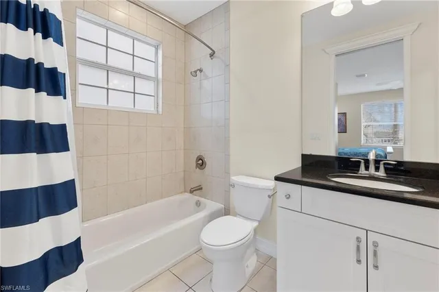 a bathroom with a sink a toilet a vanity and bathtub