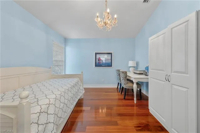 a bed room with a bed and a chandelier