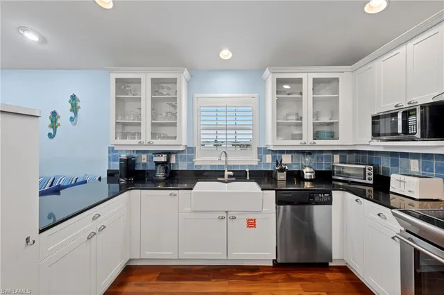 a kitchen with a stove a sink and a microwave