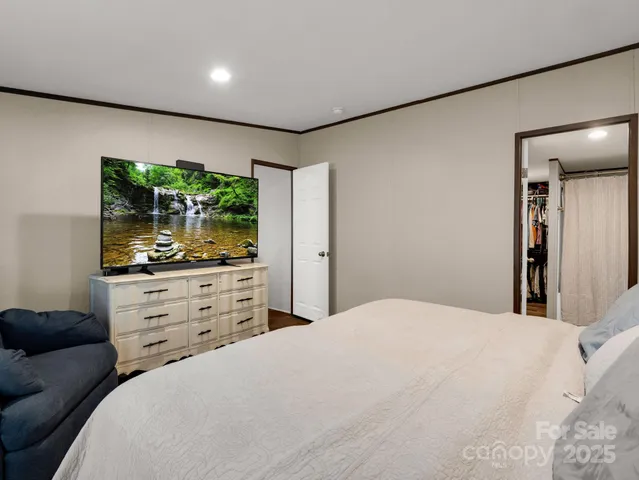 a bedroom with a bed and a large window