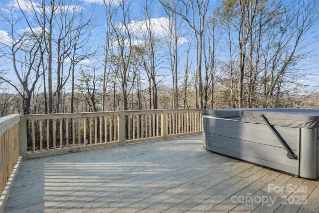 a view of backyard with wooden fence and large trees