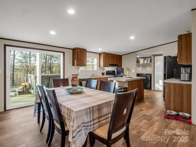 a kitchen with a table chairs refrigerator and microwave