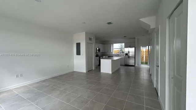 a view of a kitchen with a sink cabinets and a floor to ceiling window
