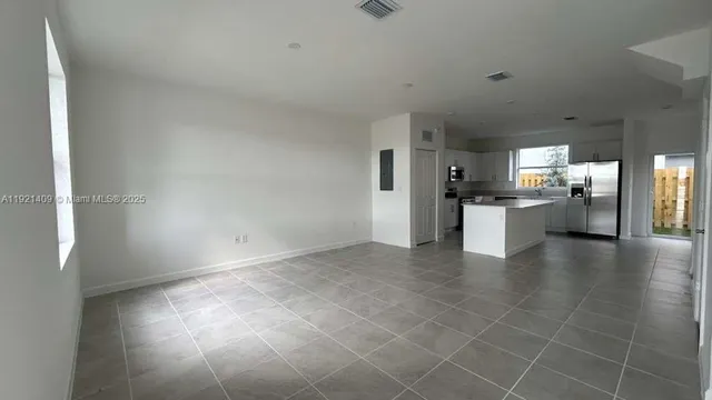 a view of a kitchen with a sink and a stove top oven