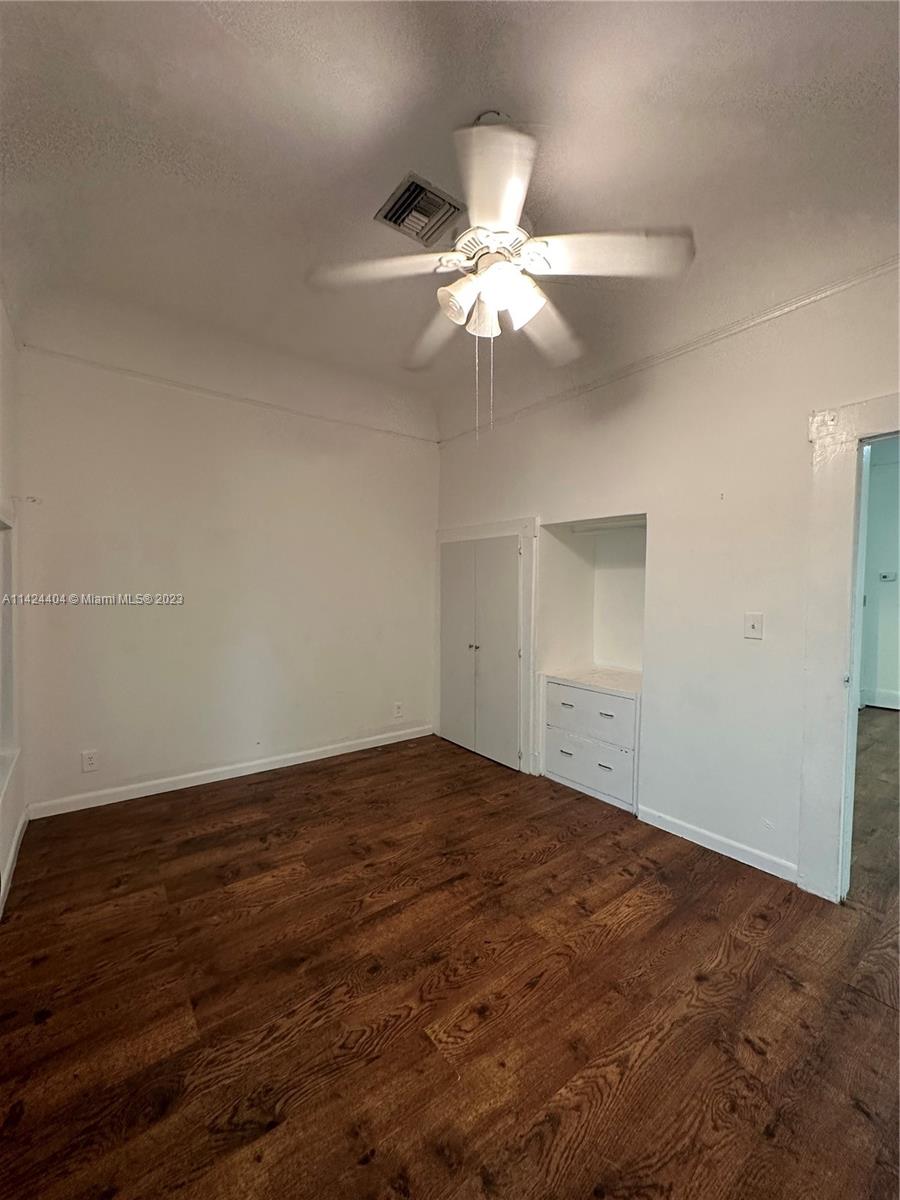 2430 Southwest 25th Terrace, Unit A Miami, FL 33133 - Photo 2 of 19 an empty room with closet and fan