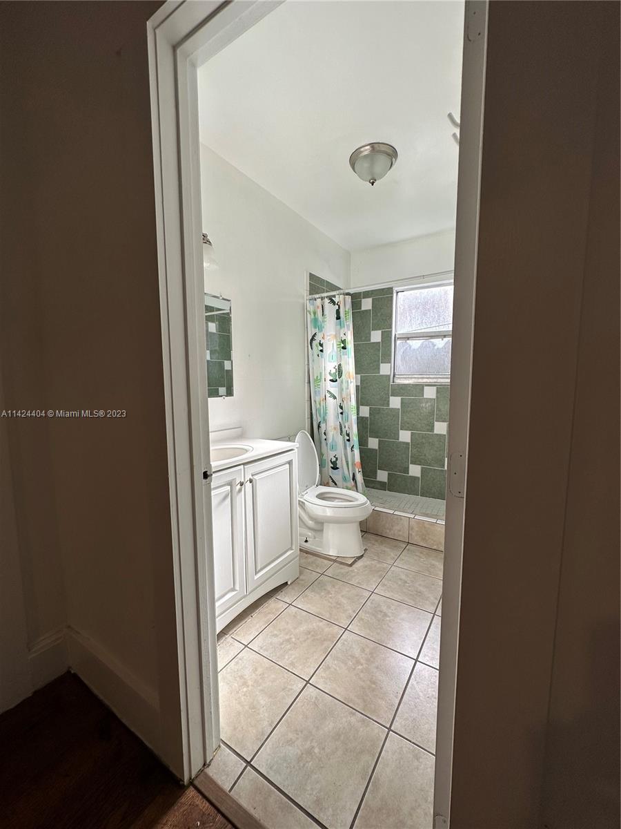 2430 Southwest 25th Terrace, Unit A Miami, FL 33133 - Photo 3 of 19 a bathroom with a sink a toilet and shower