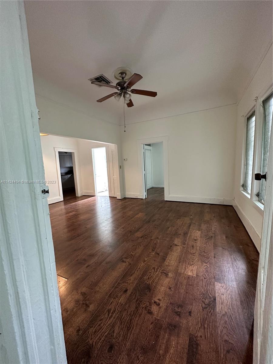 2430 Southwest 25th Terrace, Unit A Miami, FL 33133 - Photo 5 of 19 wooden floor in an empty room with a window