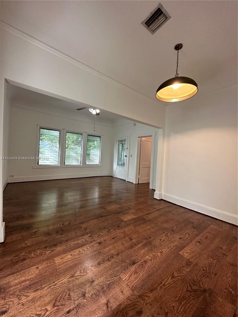 2430 Southwest 25th Terrace, Unit A Miami, FL 33133 - Photo 7 of 19 a view of room with window and wooden floor