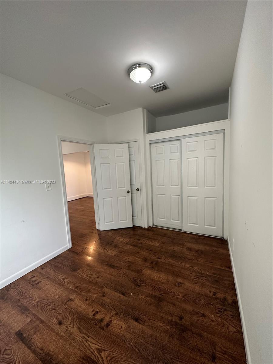 2430 Southwest 25th Terrace, Unit A Miami, FL 33133 - Photo 10 of 19 wooden floor in an empty room