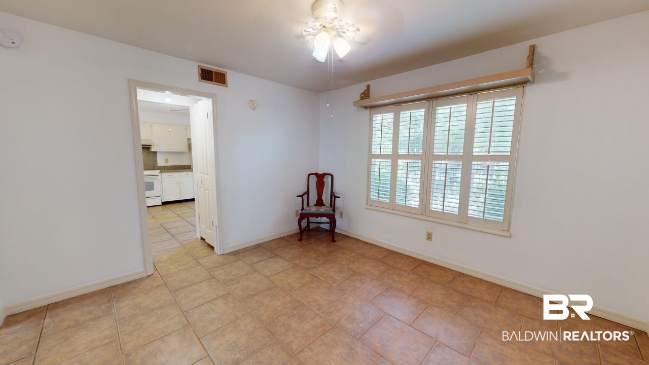 4009 Old Shell Road, Unit C13 Mobile, AL 36608 - Photo 21 of 32 Spare room featuring baseboards and ceiling fan