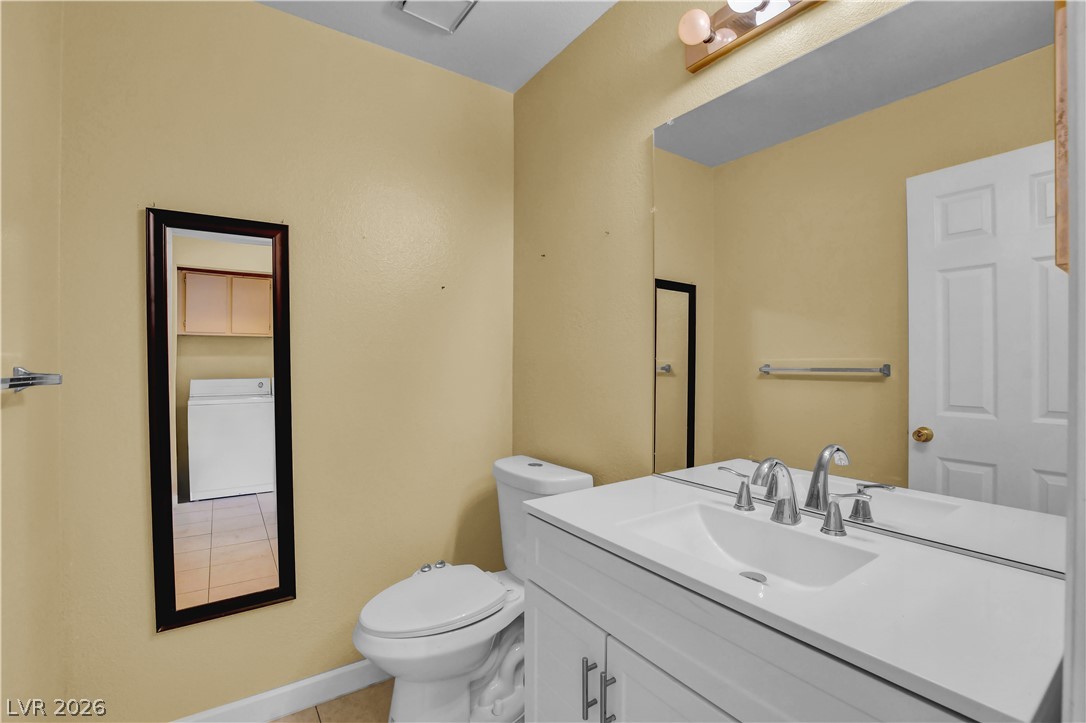 6440 Hartwood Road Las Vegas, NV 89108 - Photo 24 of 59 Functional full bathroom featuring practical tile flooring and a clean vanity with ample mirror space.