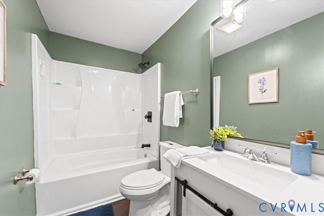 1509 Enon Church Road Chester, VA 23836 - Photo 20 of 32 a bathroom with a sink mirror toilet and bathtub