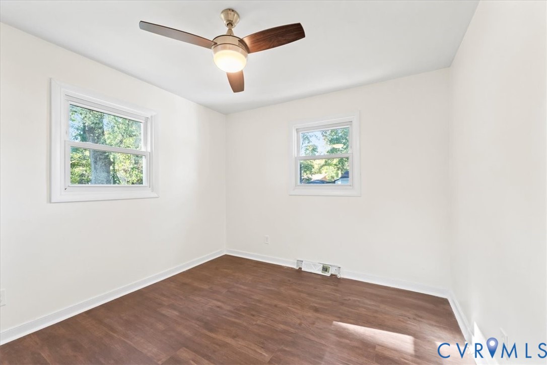 1509 Enon Church Road Chester, VA 23836 - Photo 21 of 32 an empty room with wooden floor ceiling fan and windows