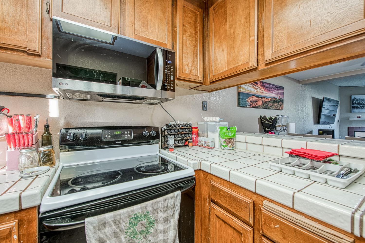 4885 North Backer Avenue, Unit 154 Fresno, CA 93726 - Photo 6 of 17 a kitchen with stainless steel appliances kitchen island granite countertop a stove and a sink