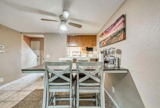 a view of a dining room with furniture and a window