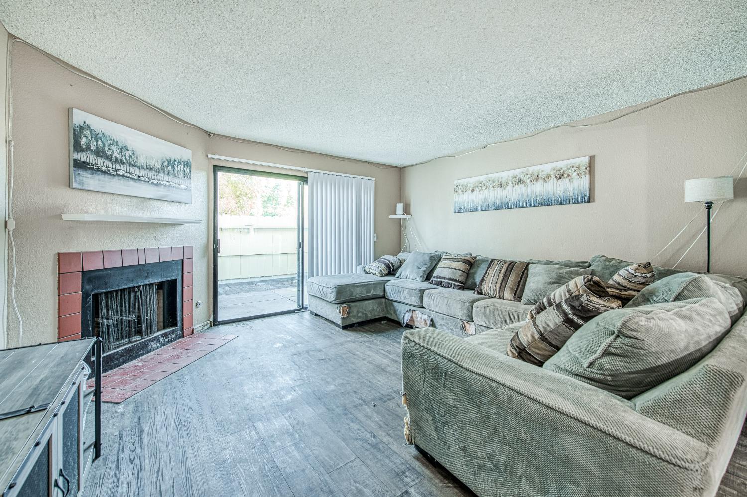 4885 North Backer Avenue, Unit 154 Fresno, CA 93726 - Photo 10 of 17 a living room with furniture and a fireplace
