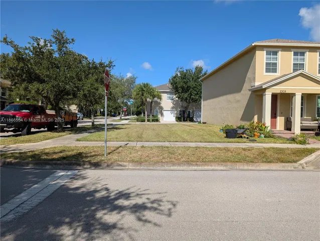 a view of a house with a yard and sitting area