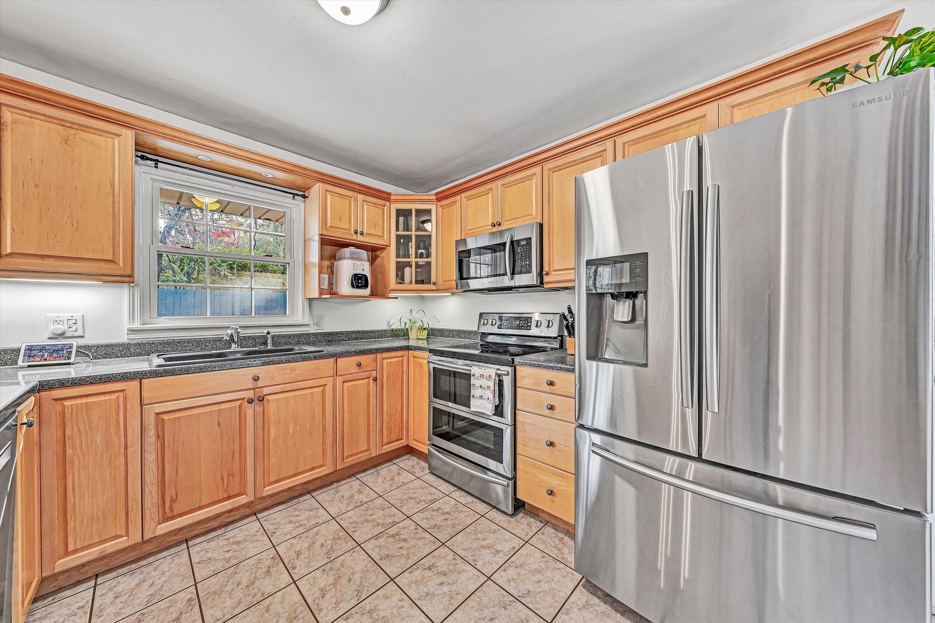 3536 Forester Road Southwest Roanoke, VA 24018 - Photo 9 of 26 a kitchen with stainless steel appliances a refrigerator sink and microwave