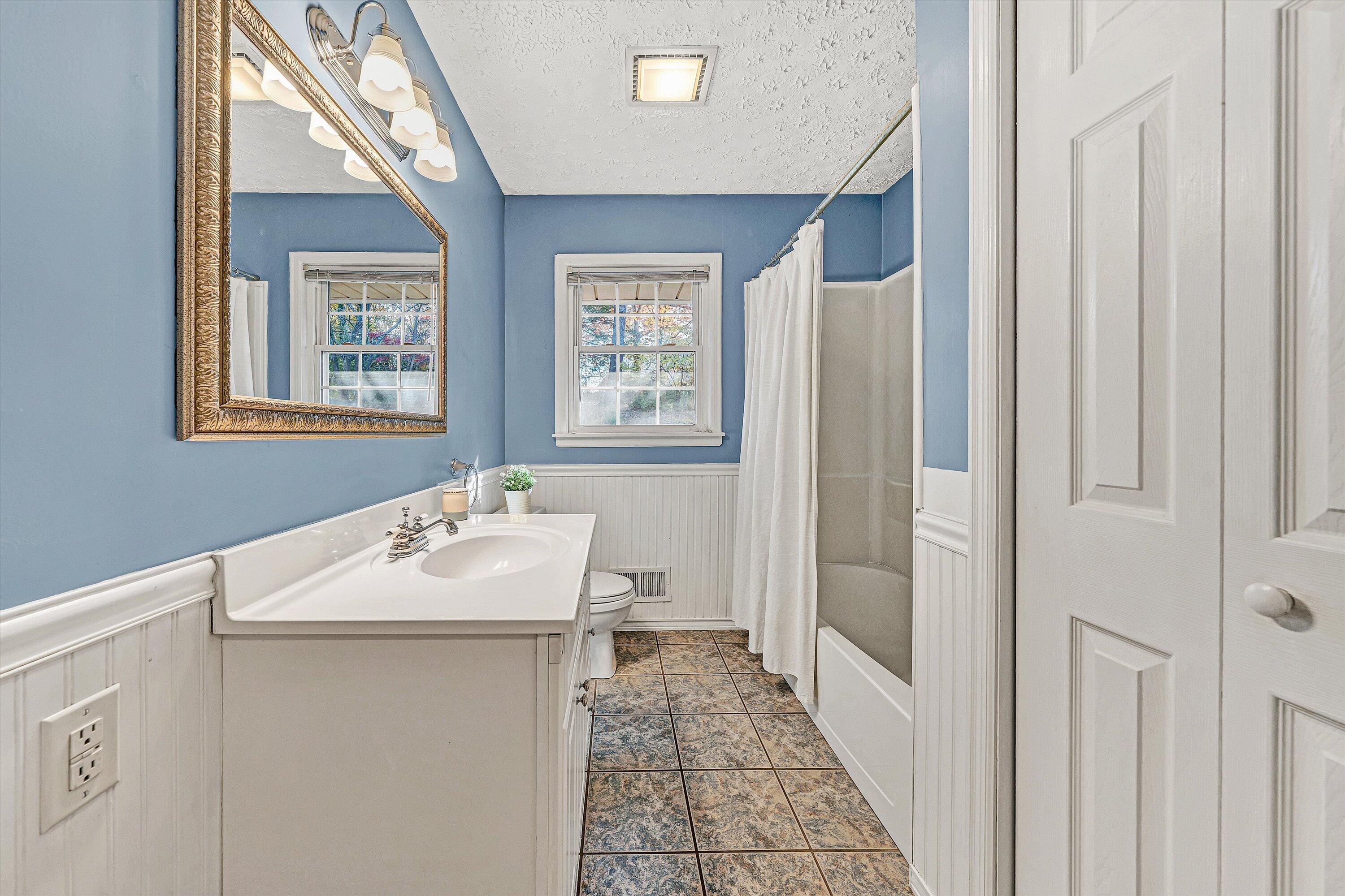 3536 Forester Road Southwest Roanoke, VA 24018 - Photo 10 of 26 a bathroom with a sink a toilet and a mirror