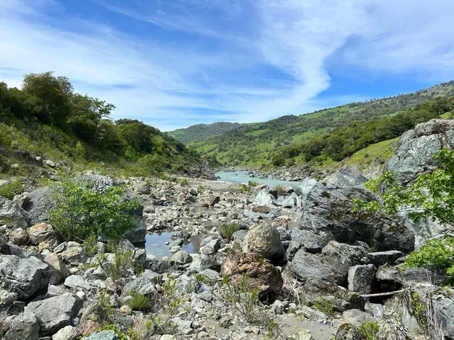 a view of a lake with beach and outdoor space
