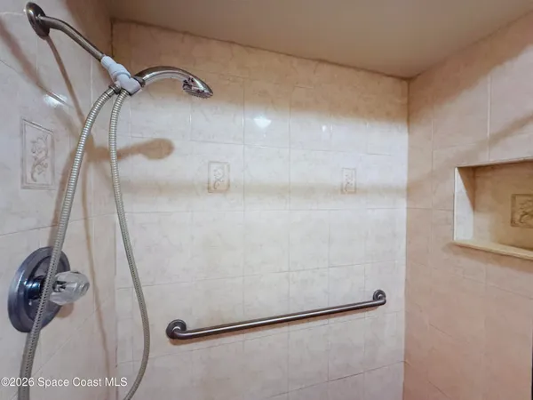 a view of a room with a sink and cabinets