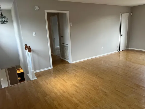 a view of a room with wooden floor