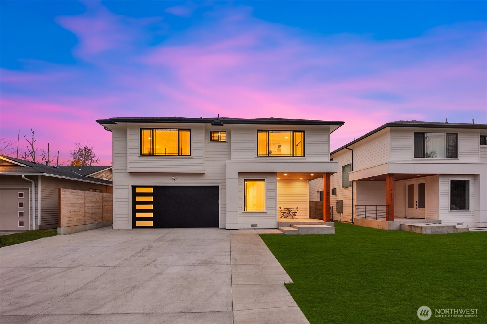 a front view of a house with a yard and garage