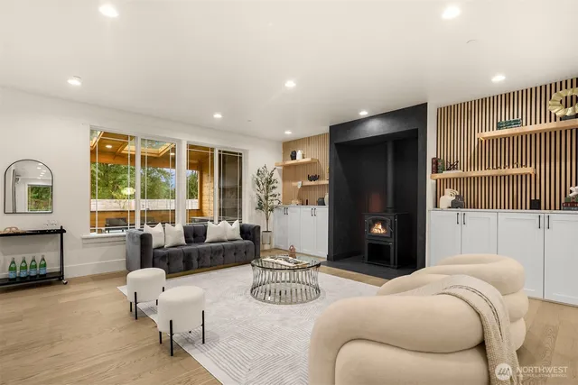 a bedroom with furniture and a large window