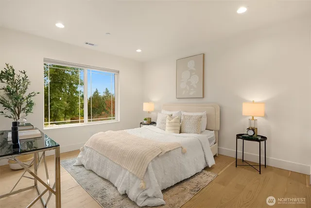 a bedroom with a bed lamps and window