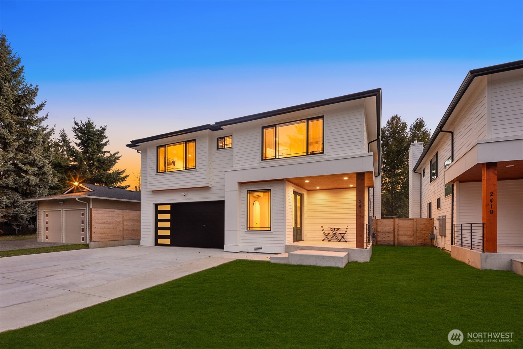 2411 Southwest 346th Street Federal Way, WA 98023 - Photo 2 of 39 a front view of a house with a yard and garage