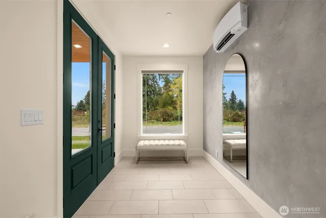a view of a hallway with furniture and windows