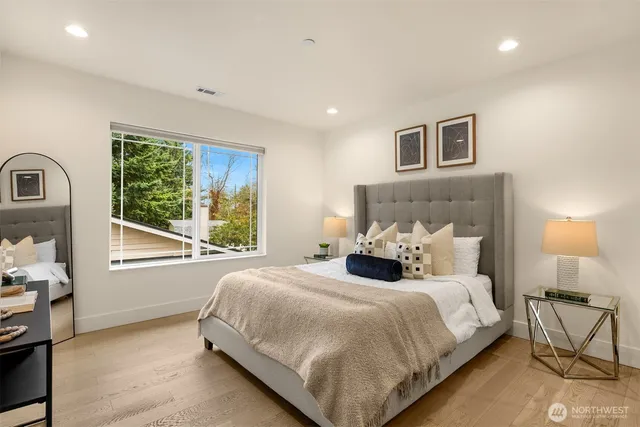 a bedroom with a bed lamps and window
