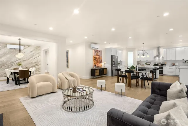 a living room with furniture kitchen and a table