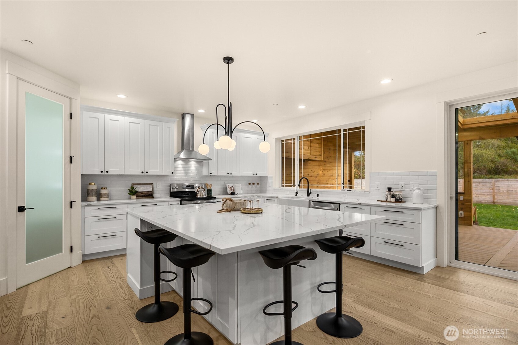 2411 Southwest 346th Street Federal Way, WA 98023 - Photo 10 of 39 a kitchen with kitchen island a stove a table and chairs in it