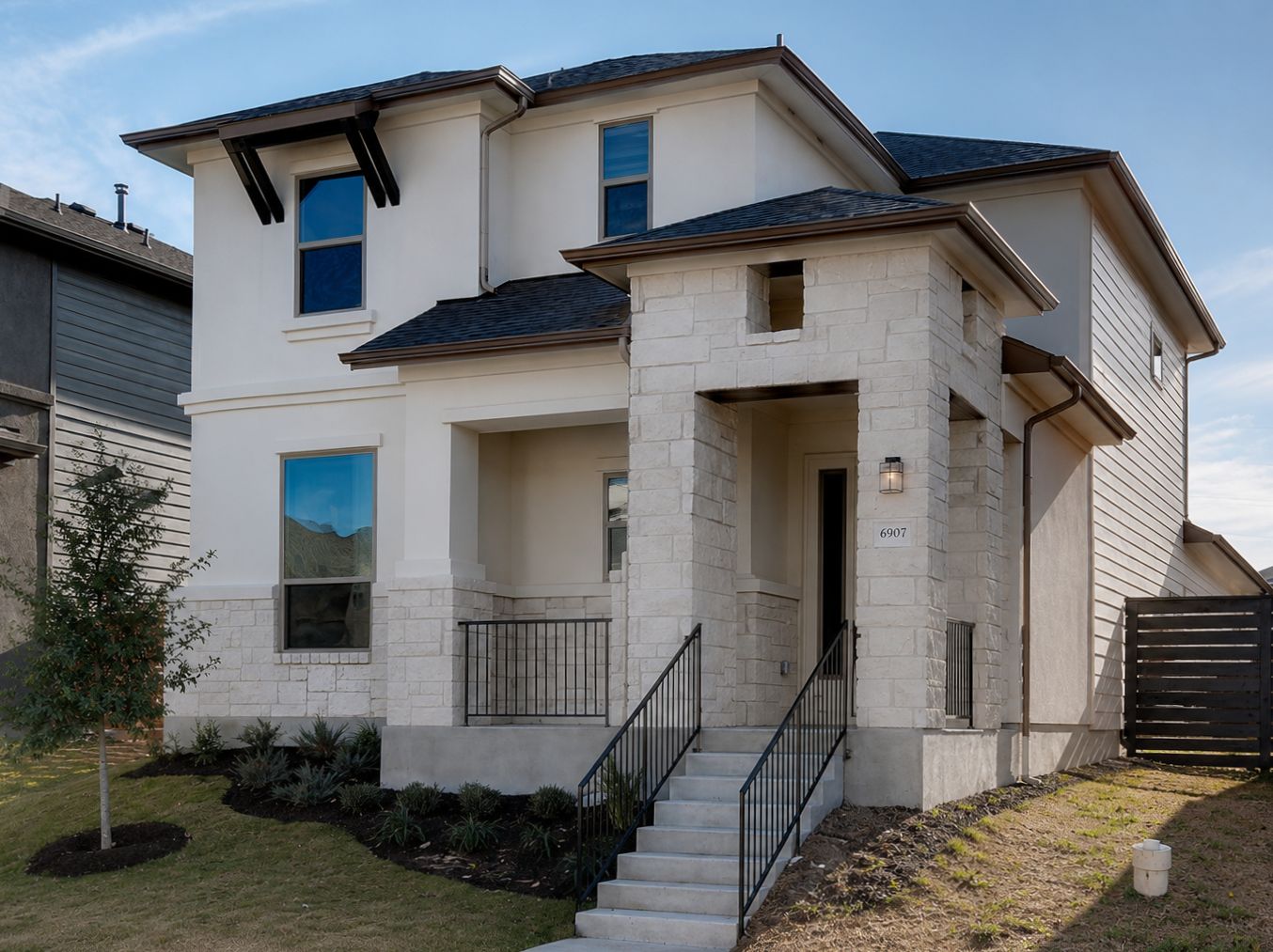 6907 Idea Road Austin, TX 78741 - Photo 1 of 29 A striking modern facade with clean lines and a welcoming stone entry beckons.