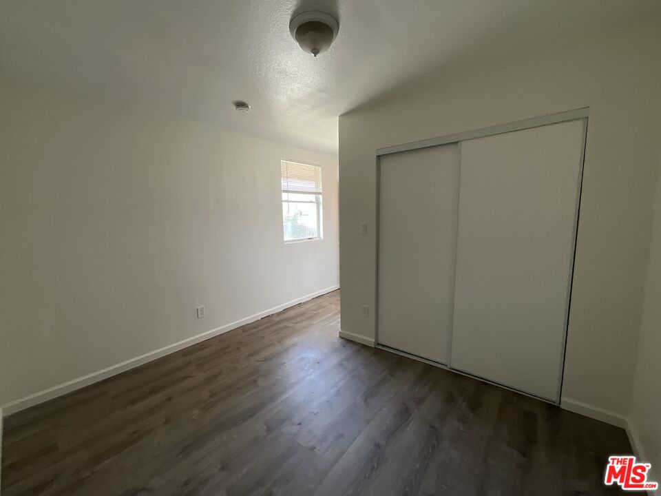 1324 North Mt Vernon Avenue Colton, CA 92324 - Photo 8 of 8 an empty room with wooden floor and windows