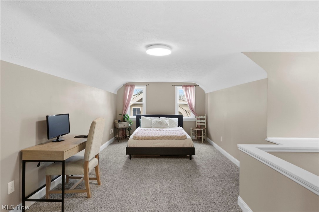 3525 Silsby Road Cleveland, OH 44118 - Photo 24 of 44 Bedroom with light colored carpet, lofted ceiling, and a desk