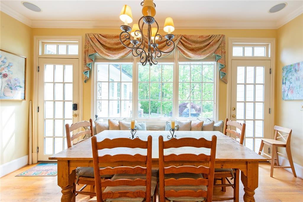 2785 Arden Road Northwest Atlanta, GA 30327 - Photo 11 of 34 a view of a dining room with furniture a chandelier and large windows