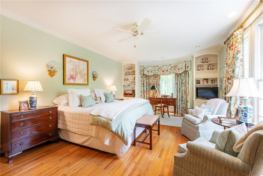2785 Arden Road Northwest Atlanta, GA 30327 - Photo 17 of 34 a bedroom with a bed and wooden floor