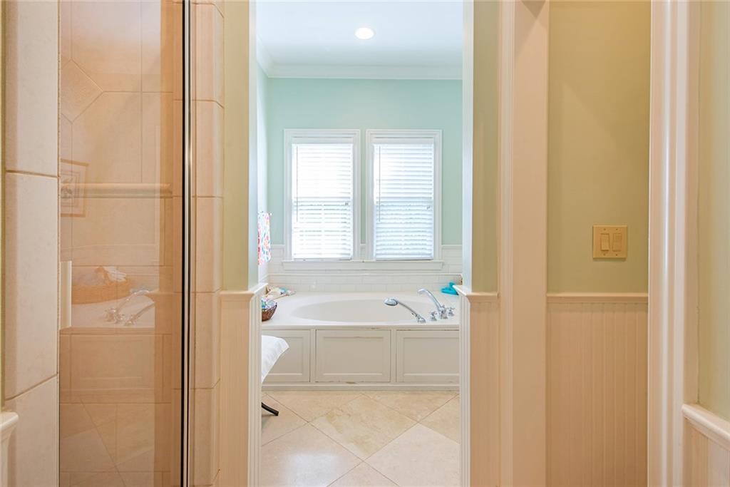 2785 Arden Road Northwest Atlanta, GA 30327 - Photo 19 of 34 a bathroom with a tub a sink and a window