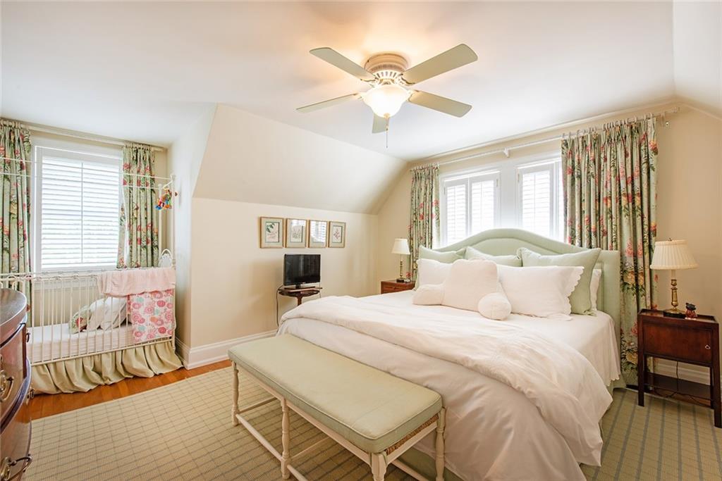 2785 Arden Road Northwest Atlanta, GA 30327 - Photo 22 of 34 a bedroom with a bed and a chandelier