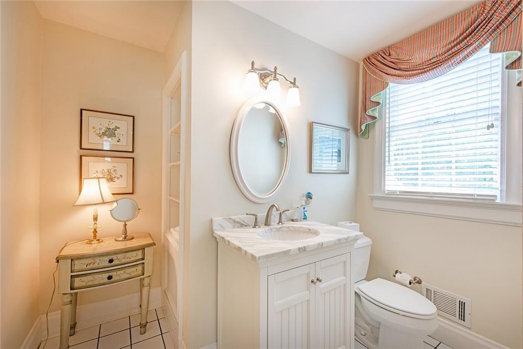 2785 Arden Road Northwest Atlanta, GA 30327 - Photo 23 of 34 a bathroom with a toilet sink and mirror