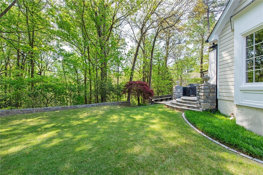 2785 Arden Road Northwest Atlanta, GA 30327 - Photo 32 of 34 a backyard of a house with table and chairs