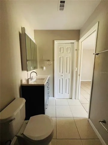 a bathroom with a sink a toilet a mirror and vanity