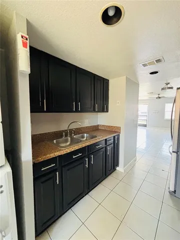 a kitchen with a sink a stove and a refrigerator